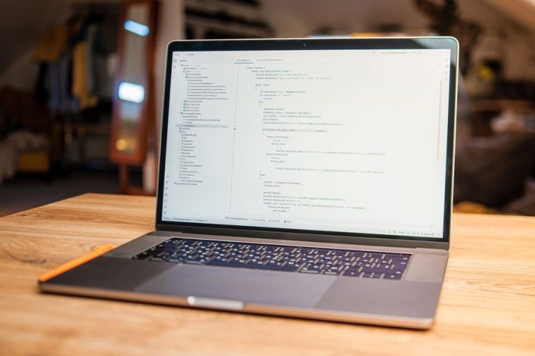 Ноутбук із кодом на столі: реєстрація ІТ-компанії SRL у Румунії